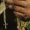 lottie holding laura lee's cross necklace with a bloodied hand in yellowjackets